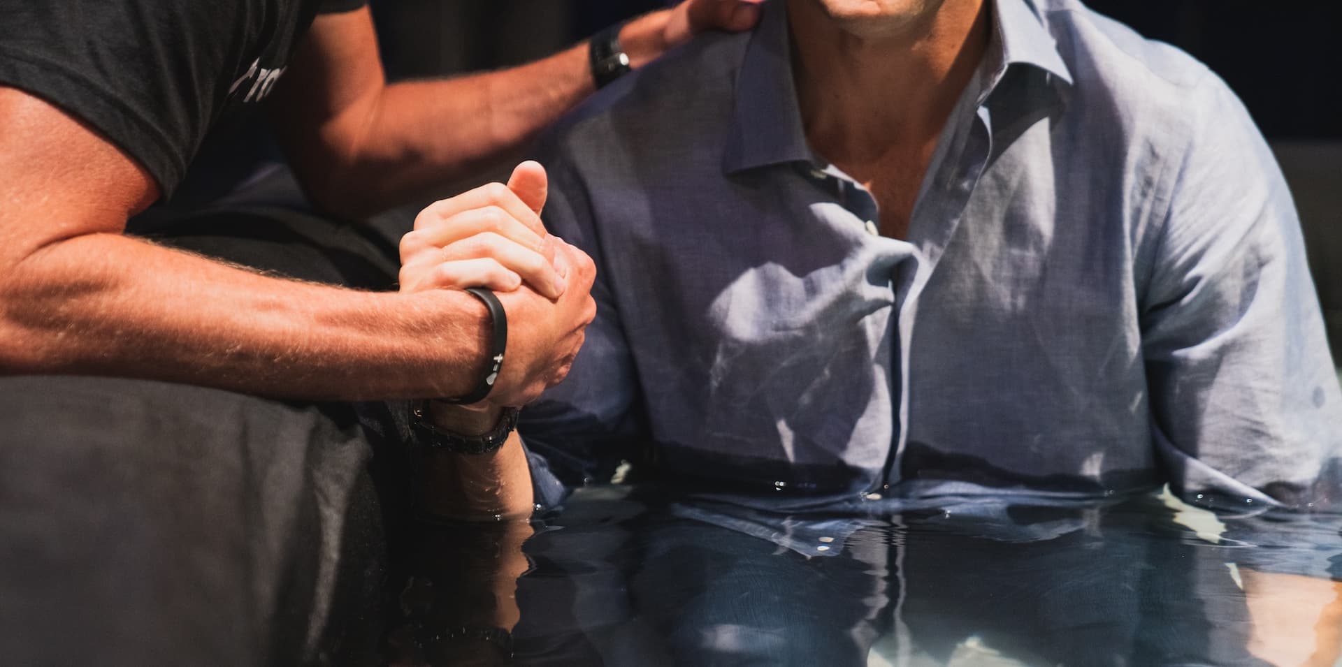 person baptizing someone in water