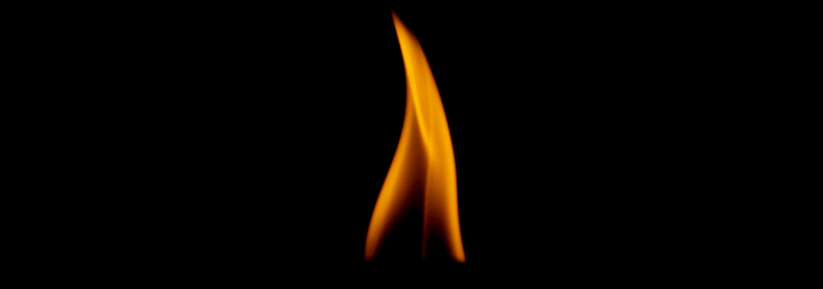 A flame against a dark background.