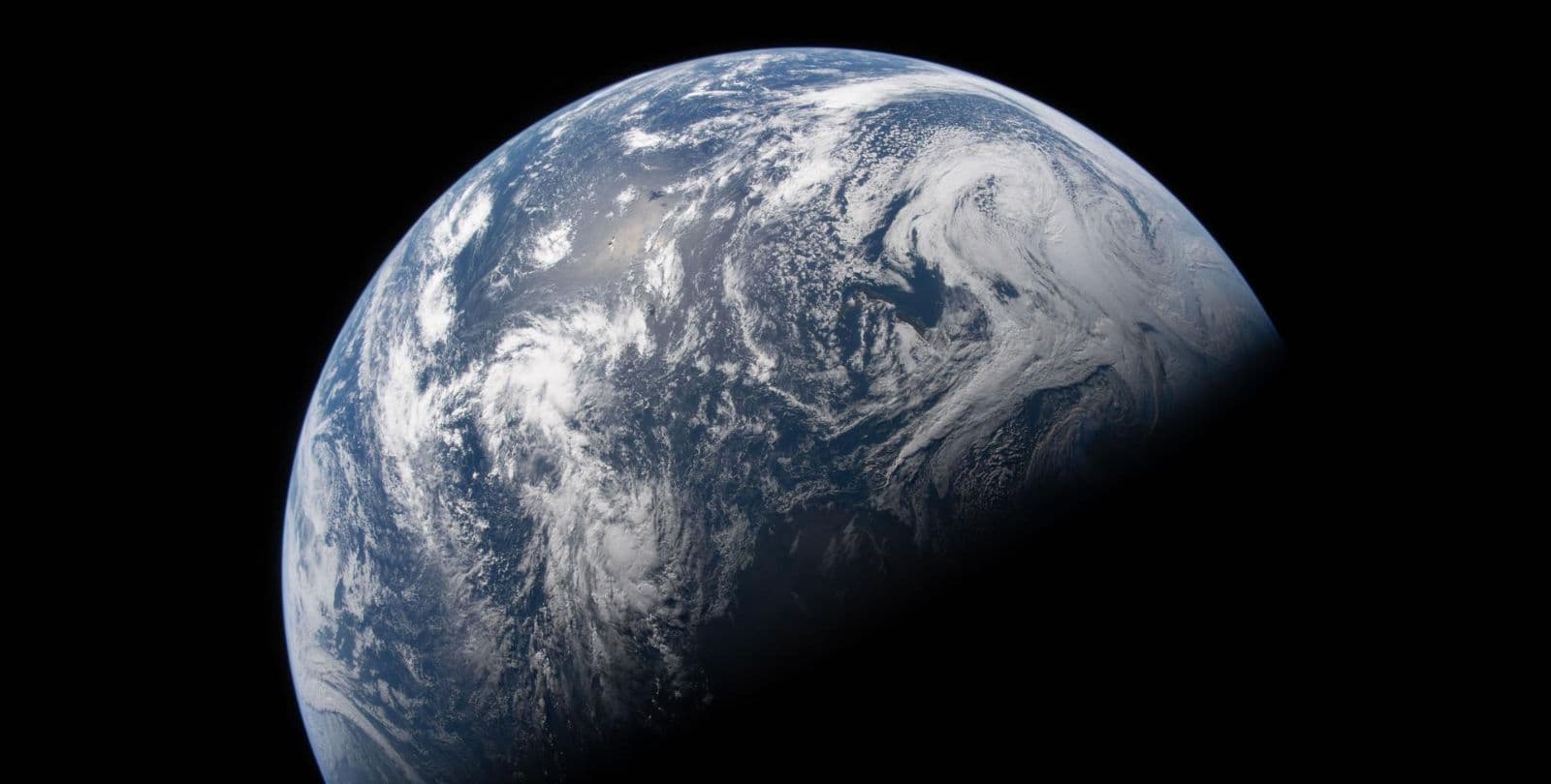 A photo of Earth from space, showing the ocean and weather systems.