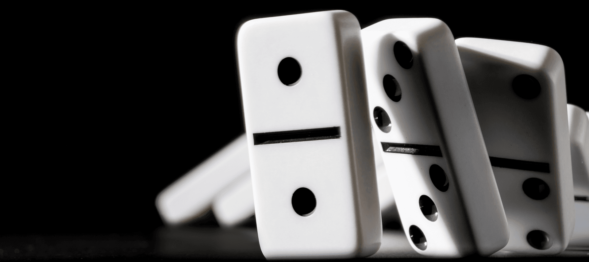 A row of dominoes are in the process of falling.