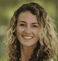 Photo of Laura rake Schulteis. Laura has brown and blond hair and she is smiling.