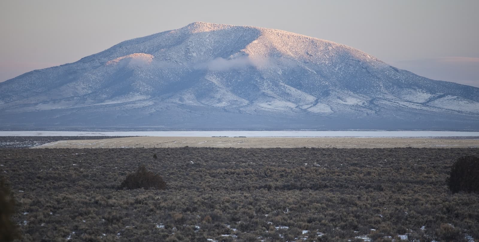 A mountain rises above the Rio Grande in the distance.
