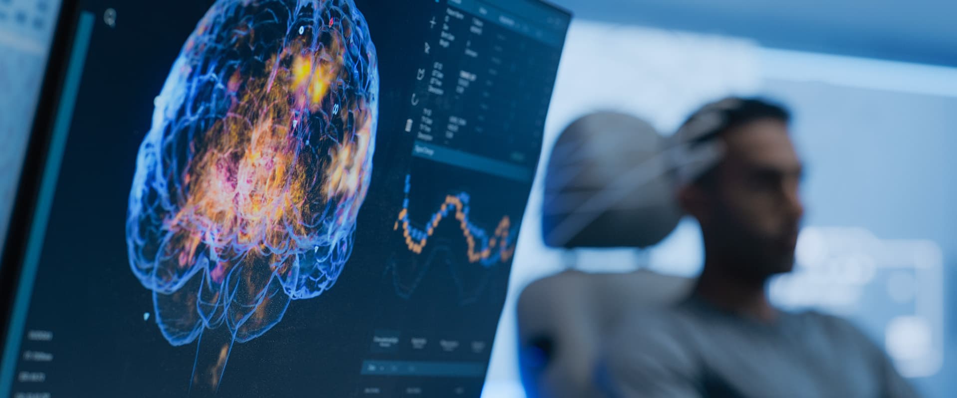 Brain scan on computer with patient in background