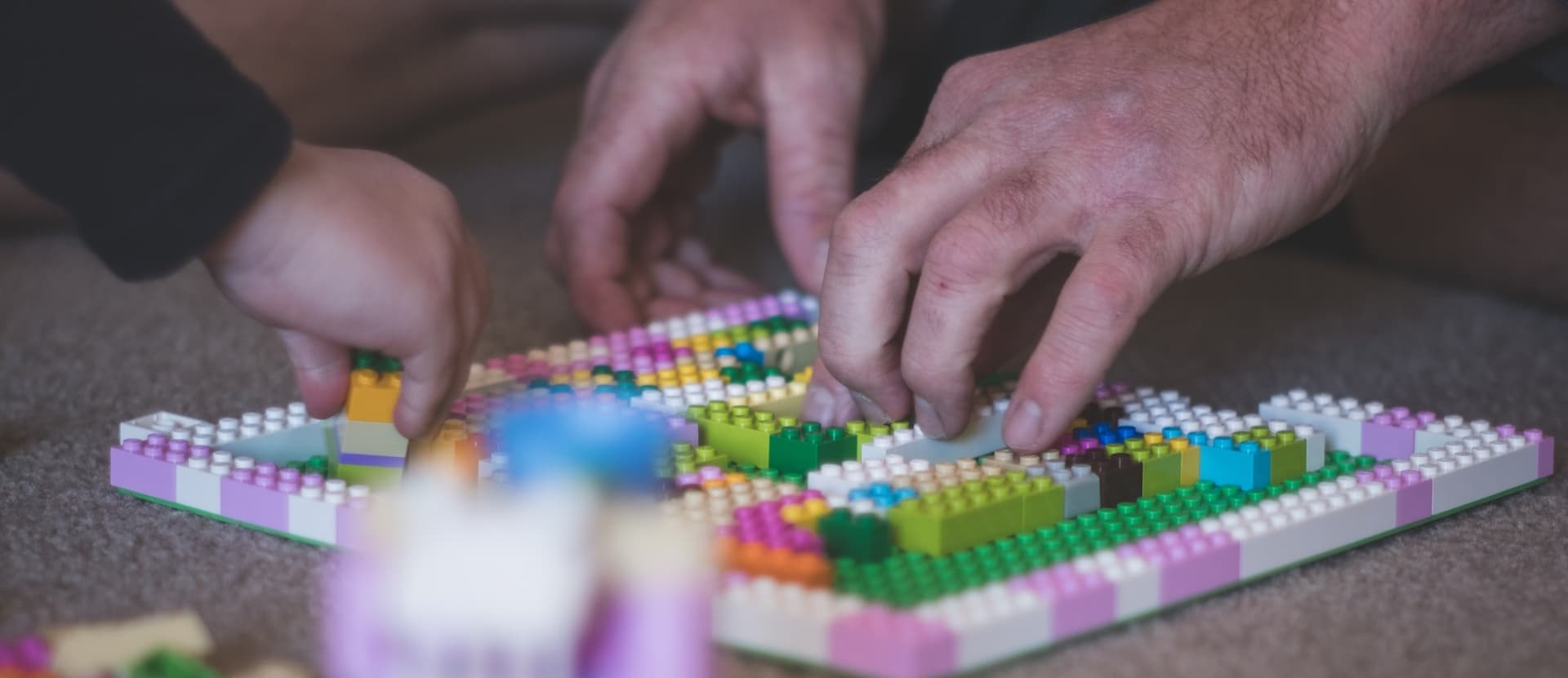 adult and child building legos